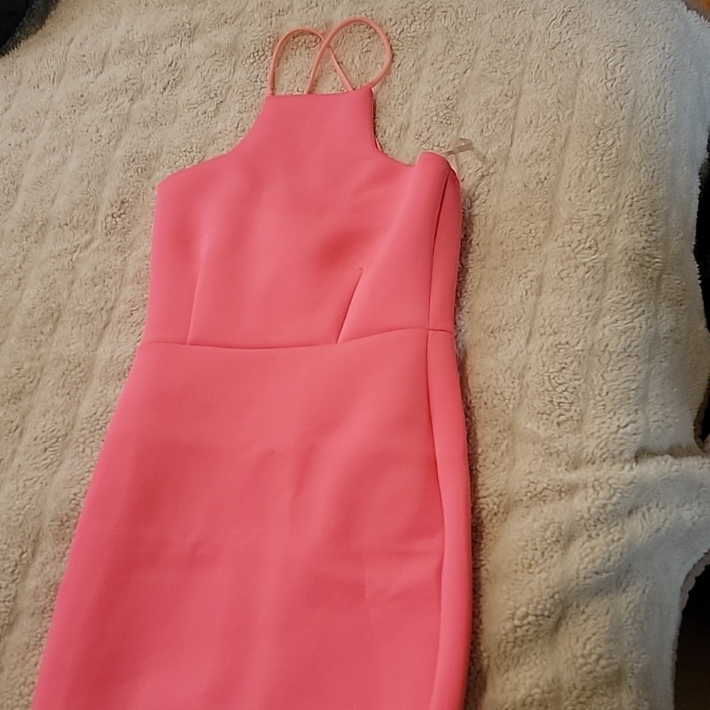 Bright pink dress with crisscross back straps.